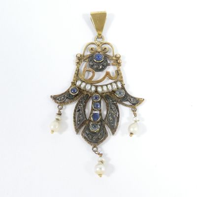an image of a close up of a pendant on a white surface