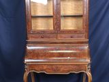 an old wooden desk with a mirror on top of it