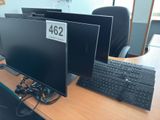 two computer monitors and a keyboard on a desk