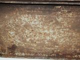 a rusted metal tray sitting on top of a white table