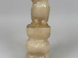 a small vase that is sitting on top of a stack of rocks