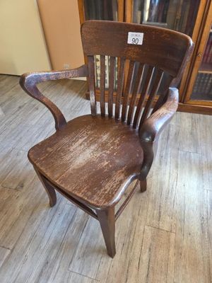 a wooden chair that is sitting on a wooden floor