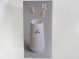 a picture of a white vase with some flowers in it