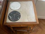 two tables that have marble top on them in a room