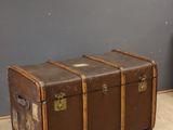 a brown trunk sitting on the floor in a room