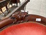 a red chair that has a price tag on the back of it