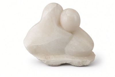 a white sculpture of a mother and child on a white surface
