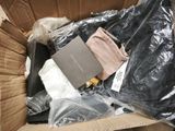 a box full of clothing and a book in it