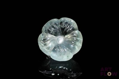 an image of a clear crystal flower on a black surface