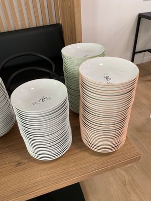 a lot of plates on a shelf in a room