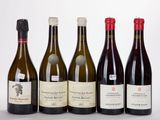 several bottles of wine are lined up on a table