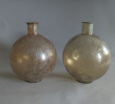 two vases sitting side by side on a white surface