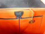 a close up of a purse with a chain hanging from it