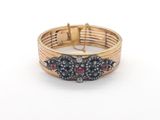 an image of a close up of a bracelet on a white surface