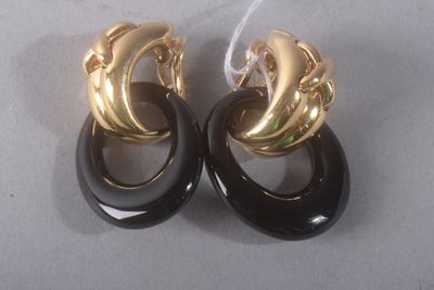pair of black and gold earrings on a white surface