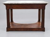 a small marble top table with a wooden base