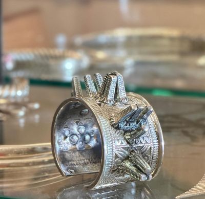 a silver ring sitting on top of a glass table