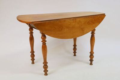 a small wooden table with a drop leaf on it