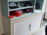 a desk with a bookcase and a chair in front of it