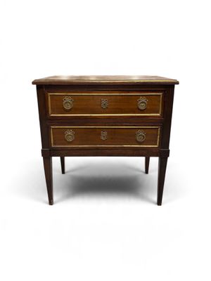 a small wooden chest of drawers on a white background
