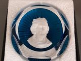an image of a glass plaque with a picture of a man in a blue circle