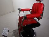 an image of a red barber chair in a white room