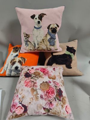 three pillows with dogs on them sitting on a chair