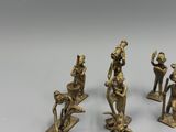 four bronze figurines of people with a dog and a cat