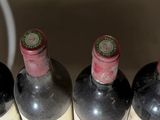 several bottles of wine are lined up in a white container