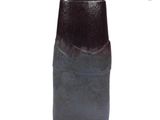 a black vase that is sitting on a white surface