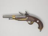 an old gun that is on a white surface