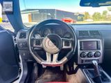 the interior of a car with a steering wheel and dashboard controls