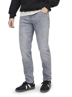a picture of a man standing with his hands in his pockets
