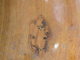 a wooden vase that has a face on it