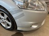 a silver car that is parked in a showroom