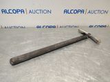 an old hammer is laying on the floor in front of a wall
