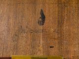a close up of a piece of wood with writing on it
