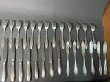 a lot of forks and spoons on a table