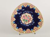 an image of a decorative plate on a stand on a white surface