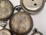 many different types of pocket watches on a white surface