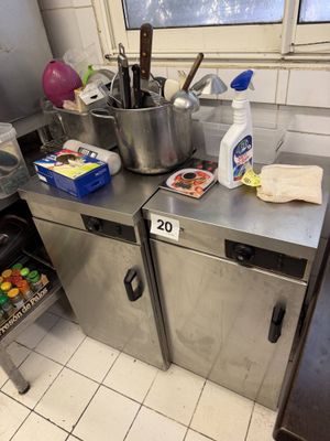 stainless steel counter top in a commercial kitchen with pots and pans on it