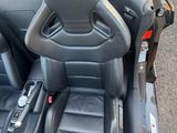 a car seat in the back of a car with a steering wheel
