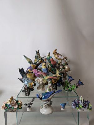 a glass table with a bunch of figurines on top of it