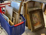 a shopping cart full of art and pictures in a store