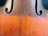 a close up of a violin that is sitting on a table