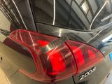 a close up of a car tail light with a sticker on it