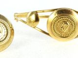 pair of gold tone cufflinks with a lion emblem