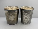 deux tasses en métal argenté portant des monogrammes