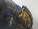 a close up of a blue vase with an elephant on it ' s head