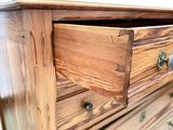a wooden dresser with a drawer on top of it